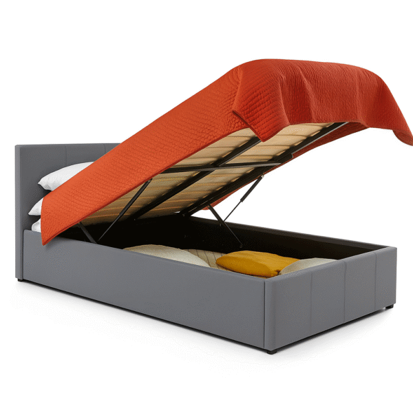 White upholstered storage bed with an orange quilted blanket lifted to reveal under-bed storage space.